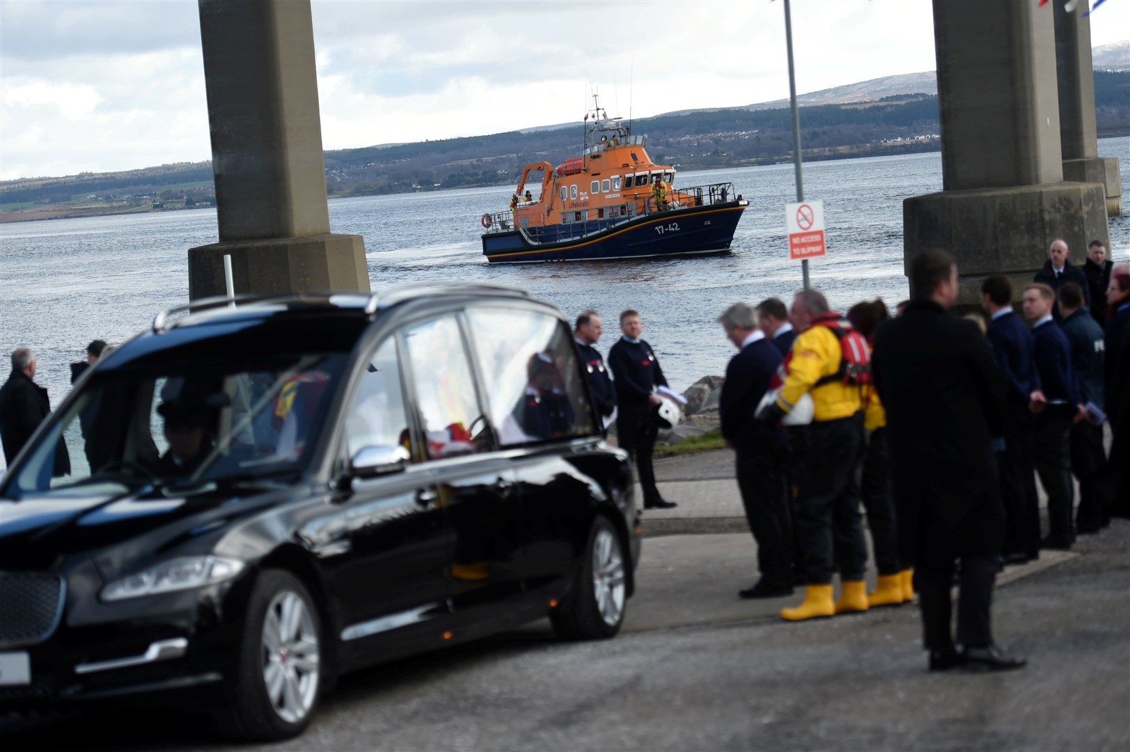 Guard of honour stands by with lifeboat in background.