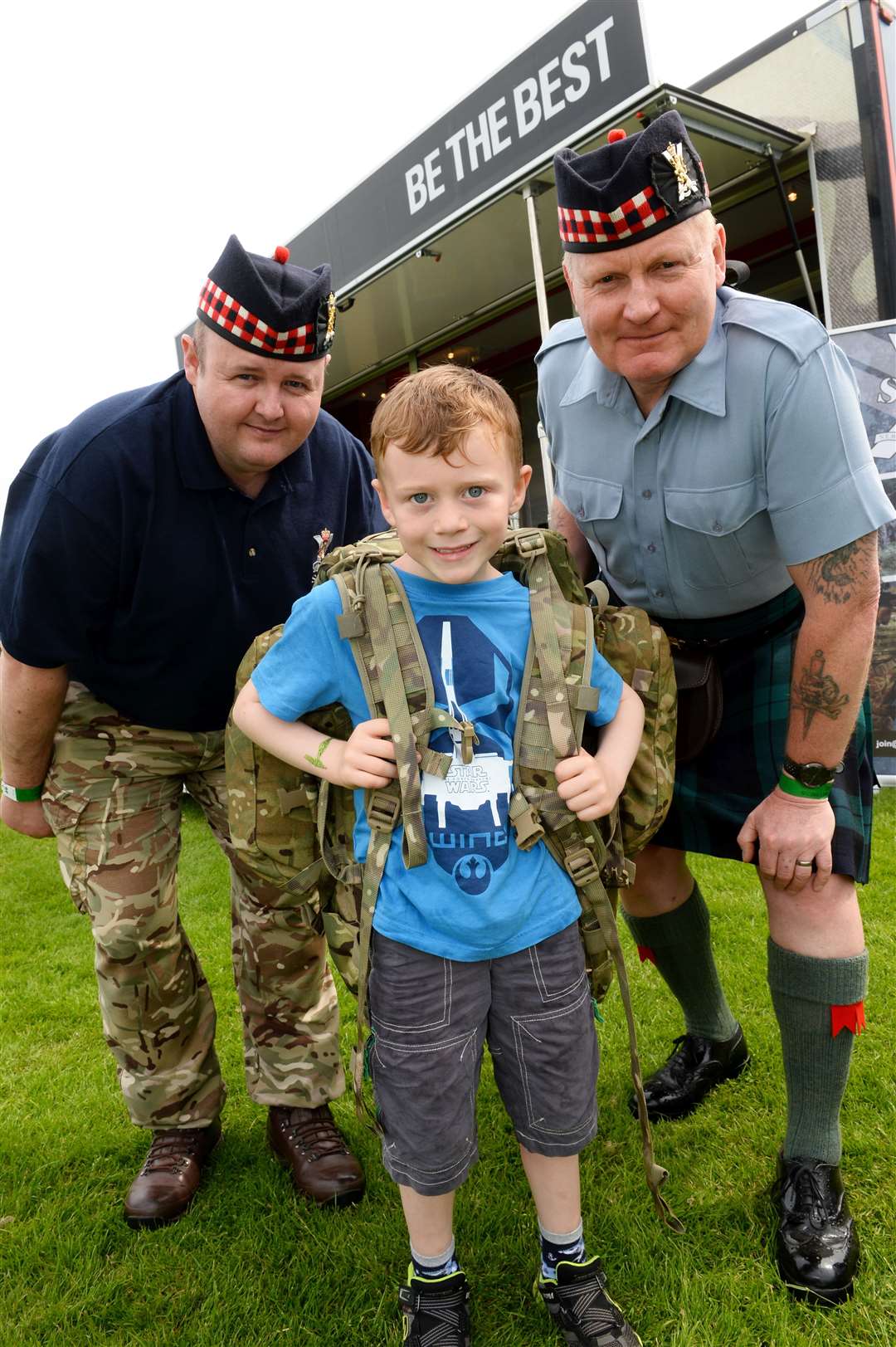 Adam MacDonald age 6 from Thurso at the 7 Scots display stand with Right, Wo2 Donald Campbell and right, Cpl Jamie Simpson. Picture: Alasdair Allen