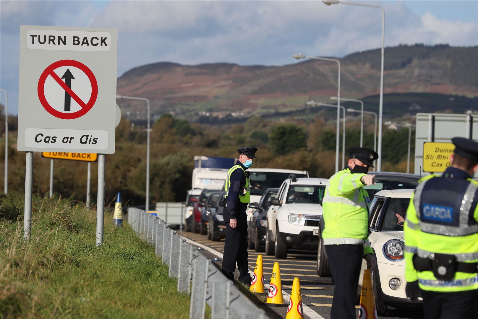Cars queue at a border crossing between Northern Ireland and the Republic of Ireland last year (PA)