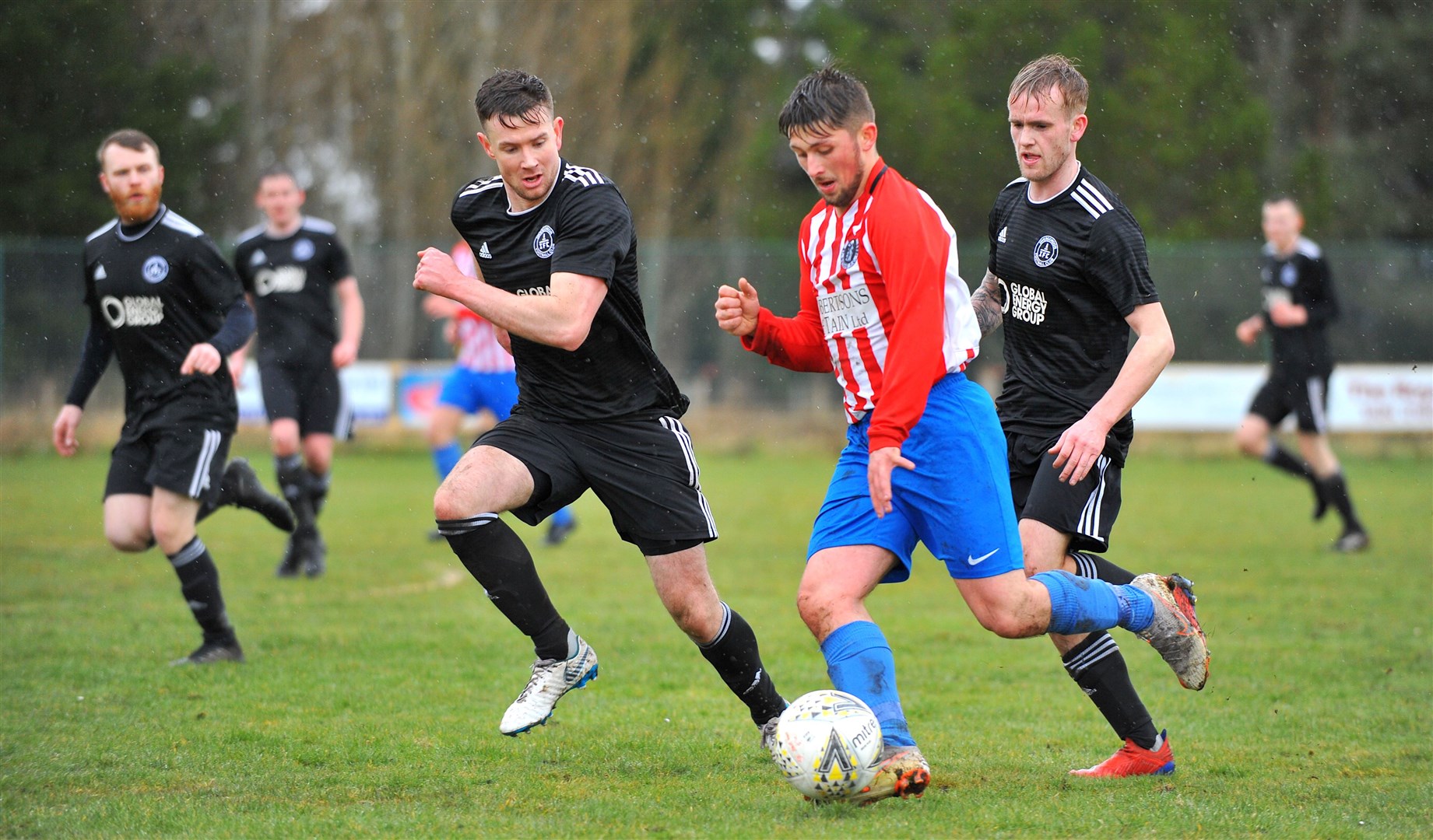 Saints's Jake Locket is crowded out by Invergordon players. Picture: Graeme Webster