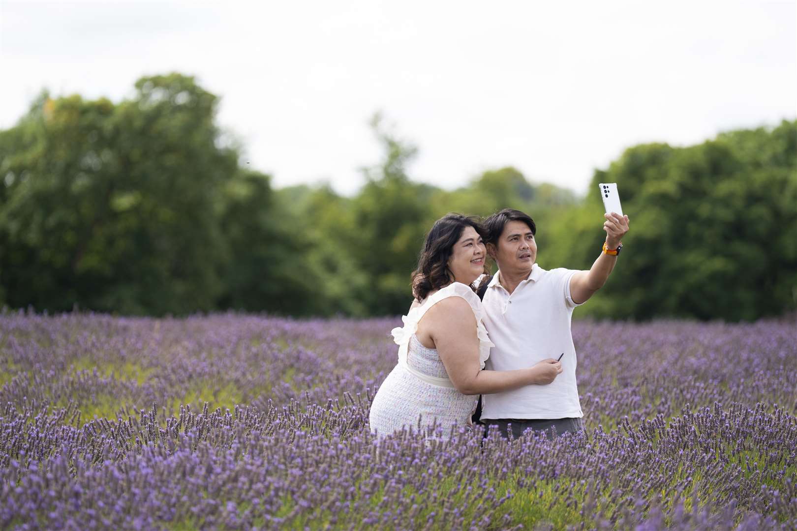 People take photographs in the lavender at Mayfield Lavender Farm in Sutton (Kirsty O’Connor/PA)