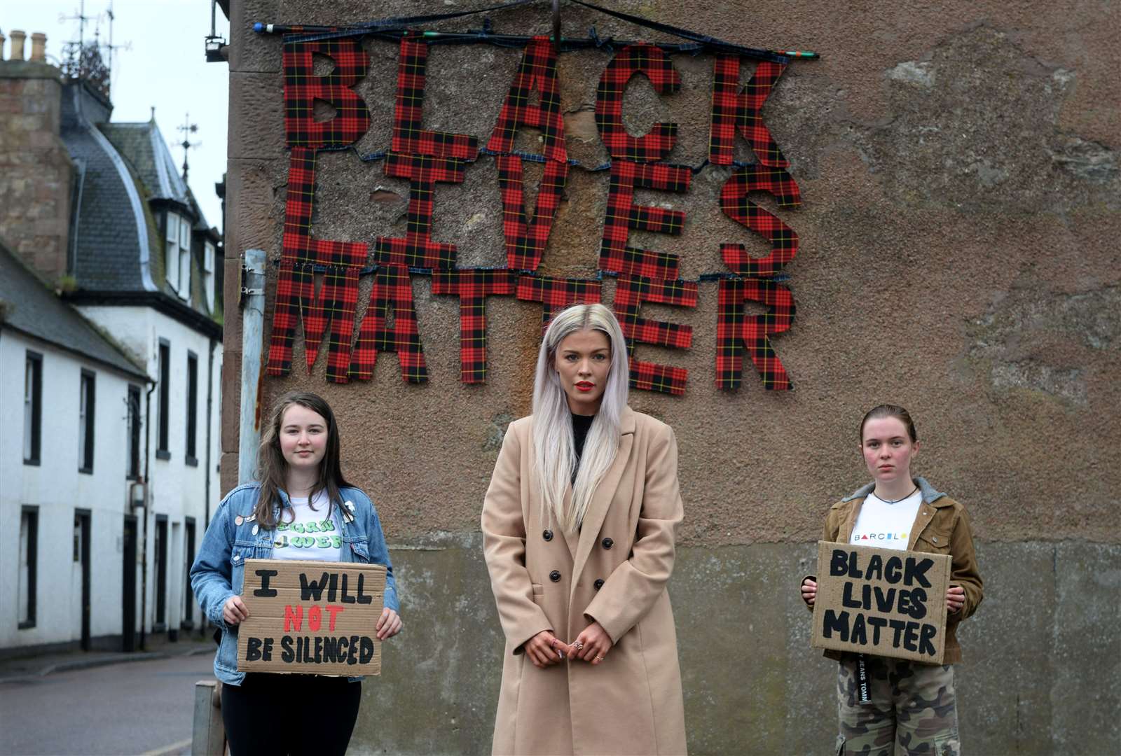 Designer Siobhan Mackenzie is supporting local campaigners Nya Gibson-Proudfoot (left) and Iona Henderson in the Black Lives Matter campaign with a specially designed sign in Fortrose. Picture: Callum Mackay