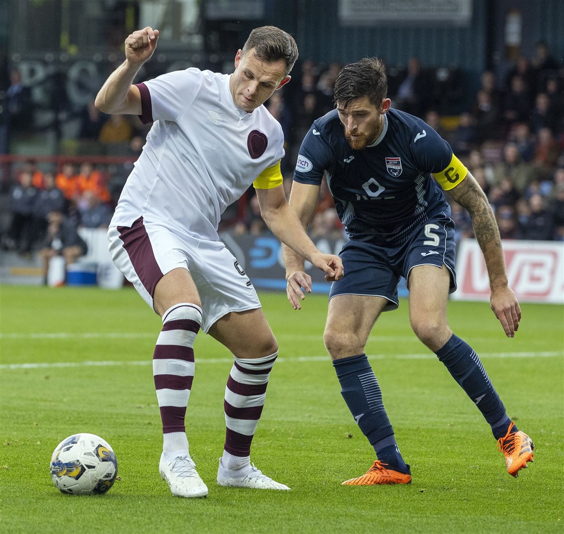 Ross County's Jack Baldwin keeps Hearts' Lawrence Shankland at bay.
