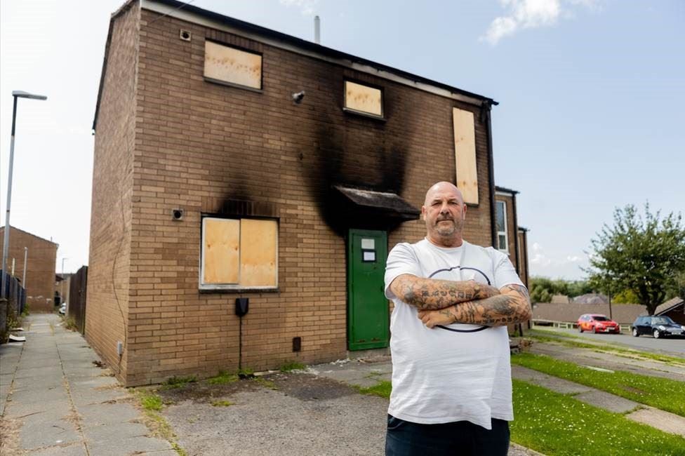 Andrew Beaton, outside his home destroyed by a fire started by an e-bike bought from an online marketplace (ElectricalSafetyFirst/PA)