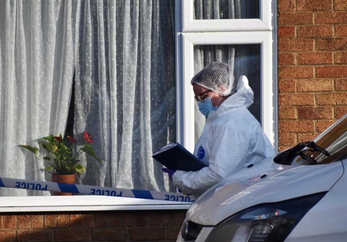 A police forensic officer at the scene in Kettering, Northamptonshire where a woman and two children were murdered (Matthew Cooper/PA)