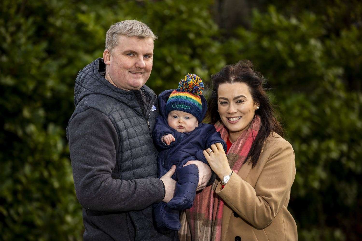 Glenn Coburn and fiancee Josey Loughran with their son Caden in a park near their home in Lisburn (Liam McBurney/PA)