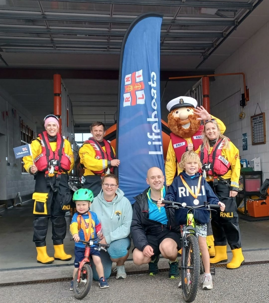 The lads were greeted at the Kessock lifeboat station after their remarkable triathlon effort.