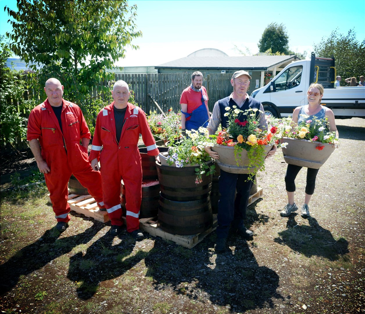 Invergordon Distillery mark their 60th anniversary with planted up barrels: Hugh Smee and Morris Bremner from Invergordon Distillery dropping off barrels for Alastair Herd, Terry Hines and Vicki Calder from Blooming Gardeners to fill with flowers. Picture: James Mackenzie