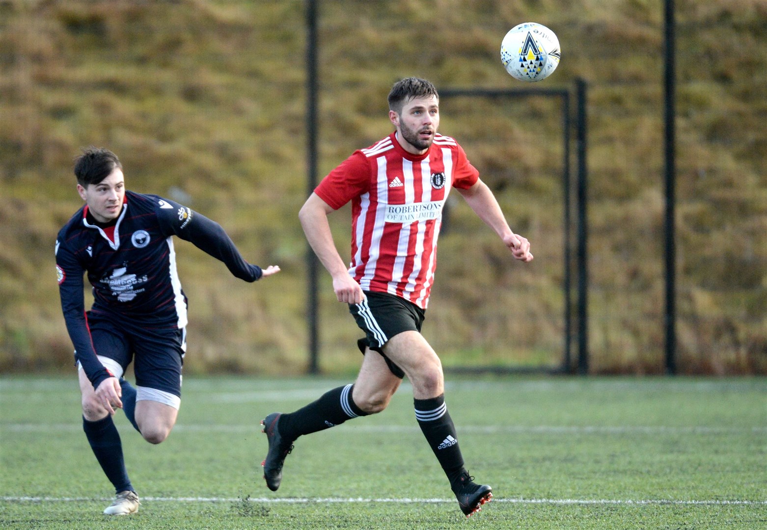 Inverness Athletic v St Duthus, North Caledonian Cup at Inverness Royal Academy: Dominic Macaulay, Inverness Athletic, chasing Gary James Millard, St Duthus. Picture: James Mackenzie.