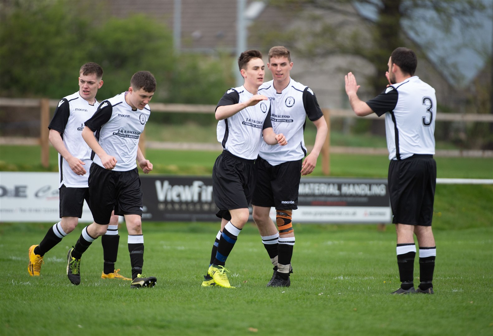 Social Club frontman Drew Sutherland is congratulated by team mates after scoring the opening goal. Picture Callum Mackay
