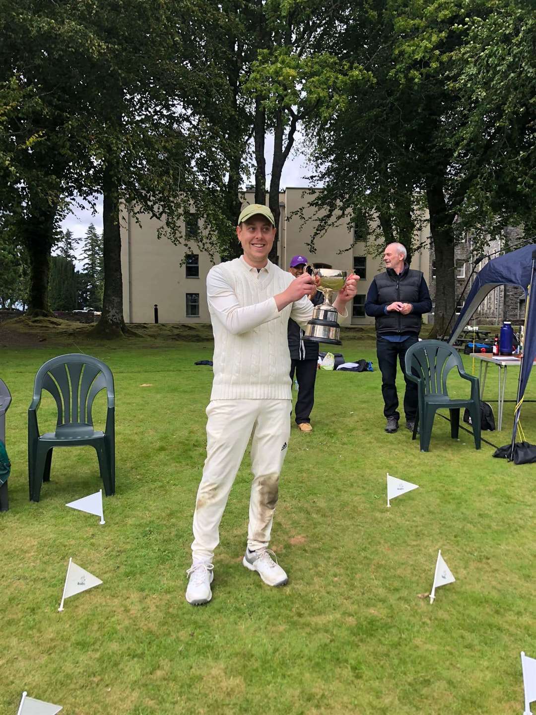 Ross County Cricket Club captain Graeme Carney holds the Senior Cup trophy aloft.