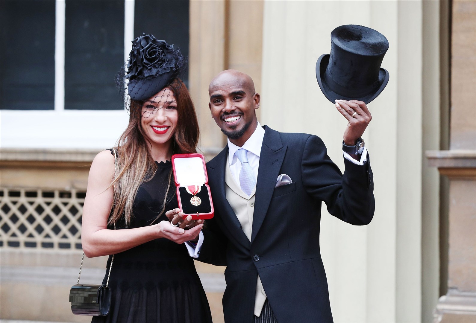 Sir Mo Farah with wife Tania after he was knighted in 2017 (Jonathan Brady/PA)