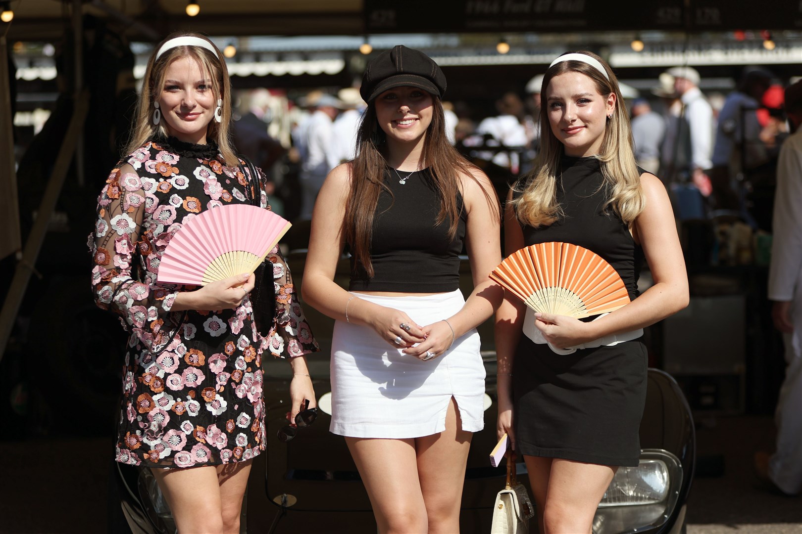 Visitors pose in Vintage Fashion at Goodwood, a revival meeting around a classic circuit (Kieran Cleeves/PA)