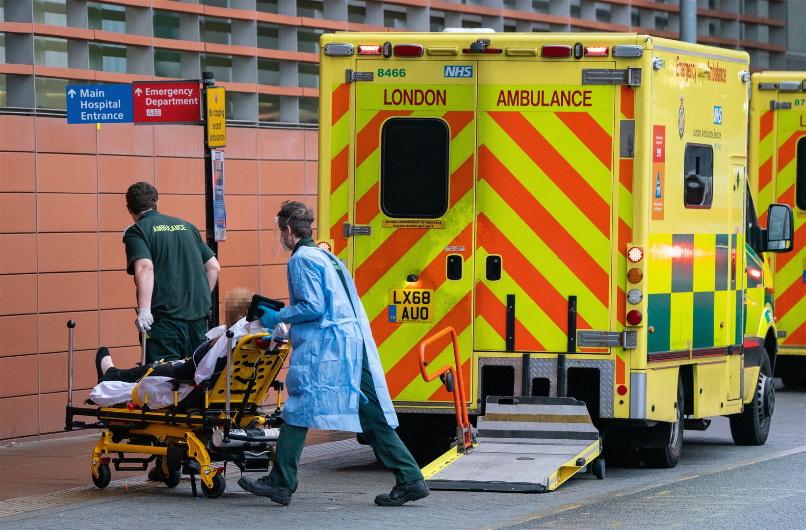 Paramedics transport a patient from an ambulance outside the Royal London Hospital (Dominic Lipinski/PA)