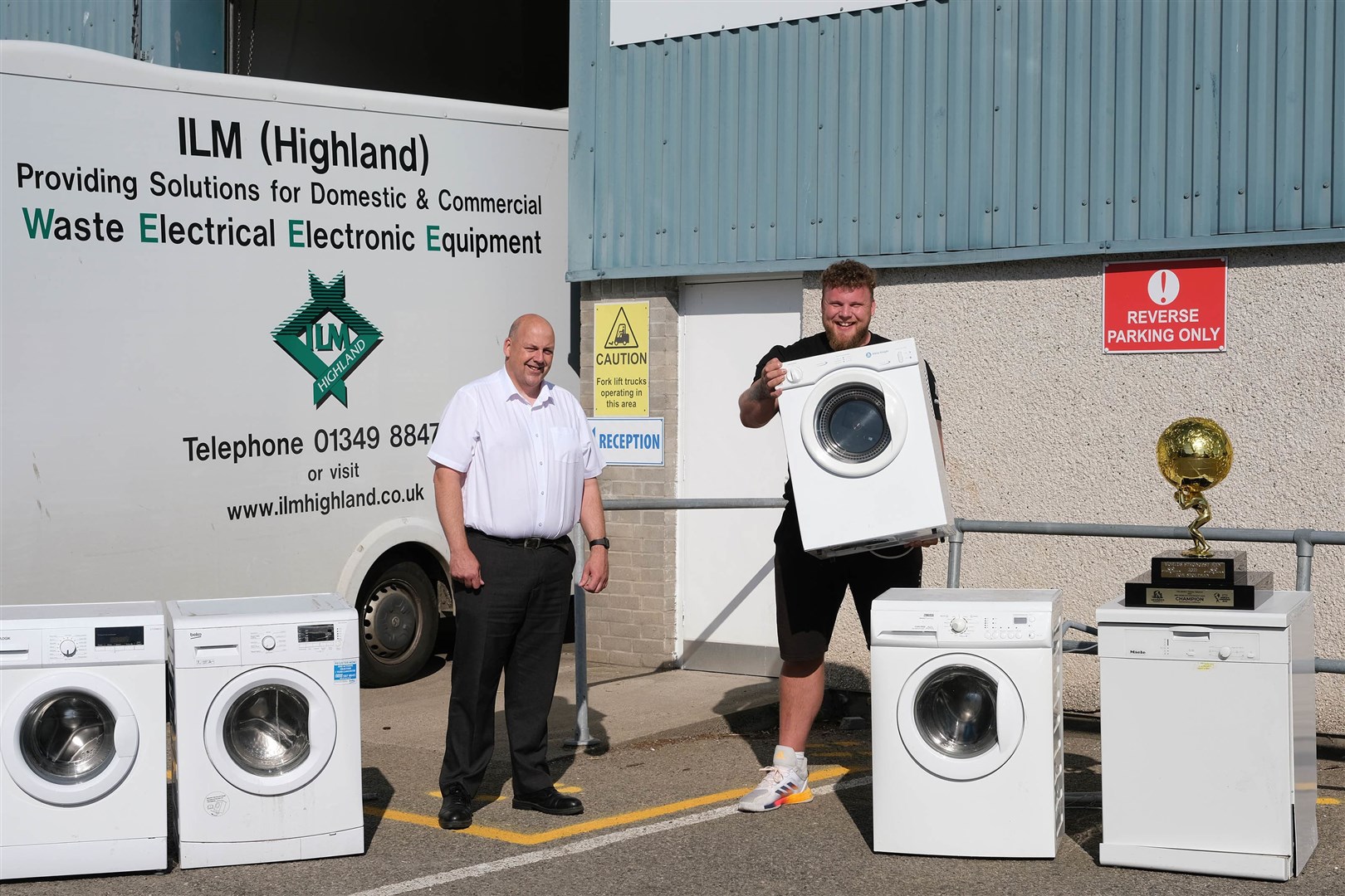 World’s Strongest Man Tom Stoltman (right) and Martin MacLeod celebrate ILM Highland’s environmental and social achievements over the last 12 months.