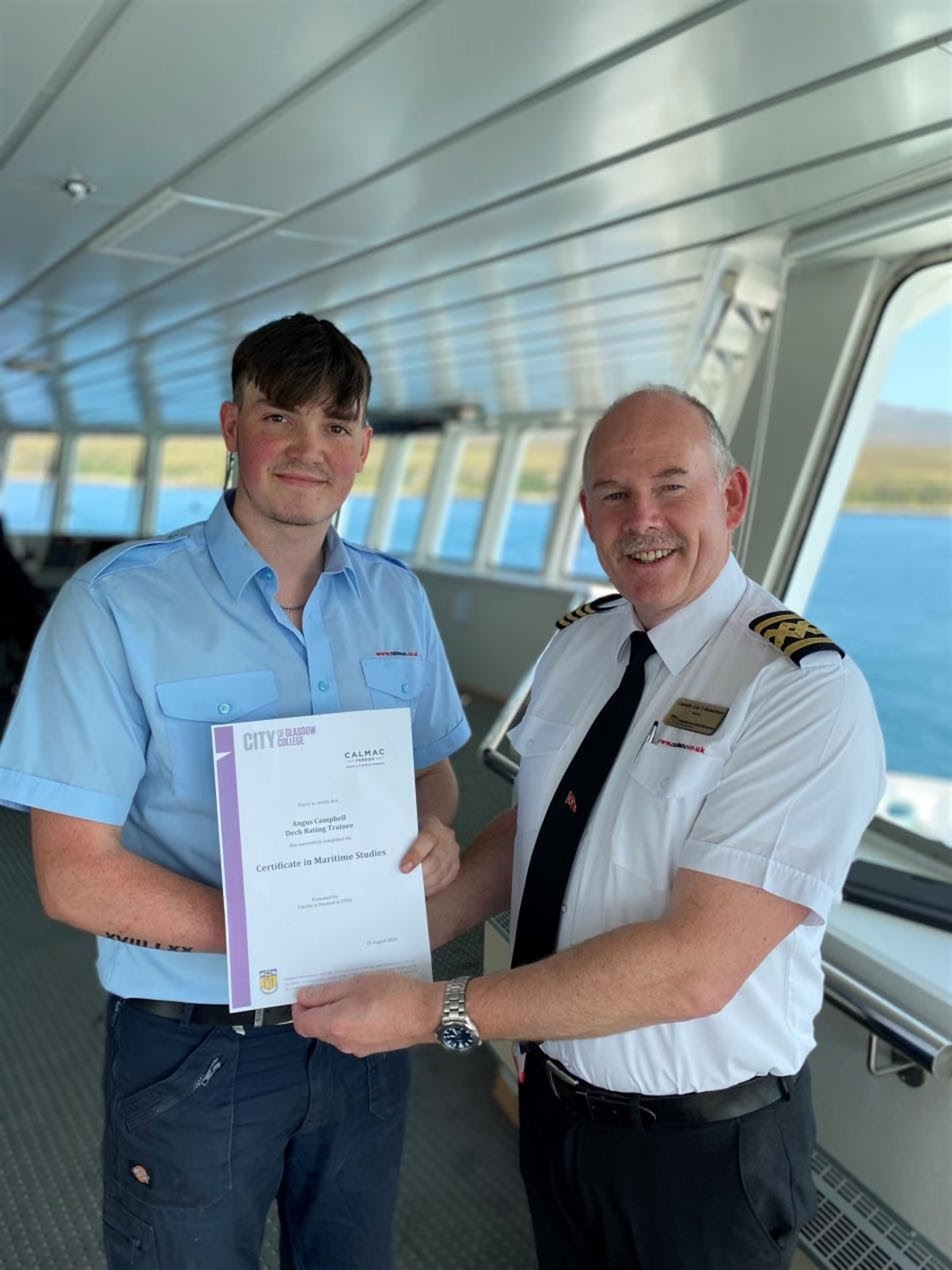 Graduate apprentice Angus Campbell, from Harris, on board MV Finlaggan with Master Guy Robertson.