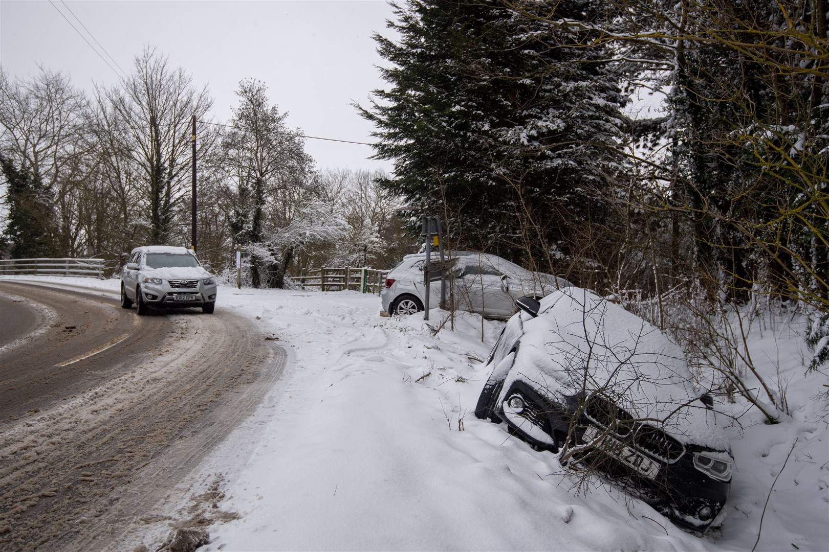 Abandoned cars in a snow-filled ditch in Needham Market, Suffolk (Joe Giddens/PA)