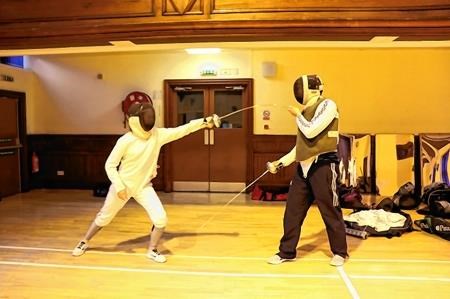 Hannah Mackenzie (left) pictured above in training with her coach Tom Hoffmann at Dingwall Fencing Club and below Hannah in action competing at a tournament.