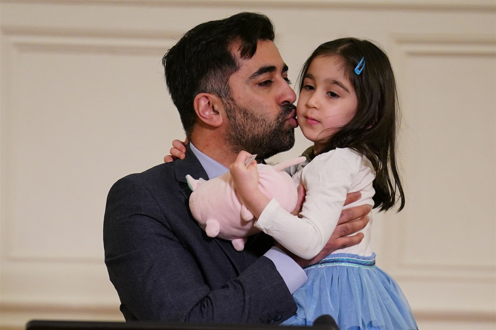 Humza Yousaf, with his daughter Amal, at the launch of his campaign at Clydebank Town Hall (Andrew Milligan/PA)