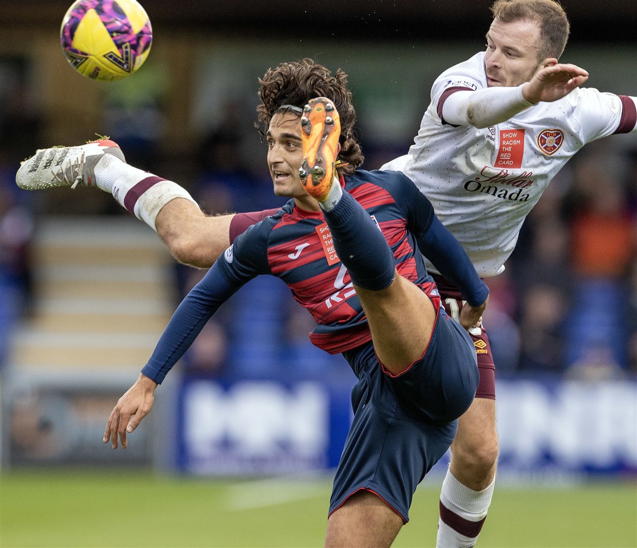 Picture - Ken Macpherson. Ross County(1) v Hearts(2). 30/10/22. Ross County's Yan Dhanda during a strong challenge on Hearts' Andrew Halliday.