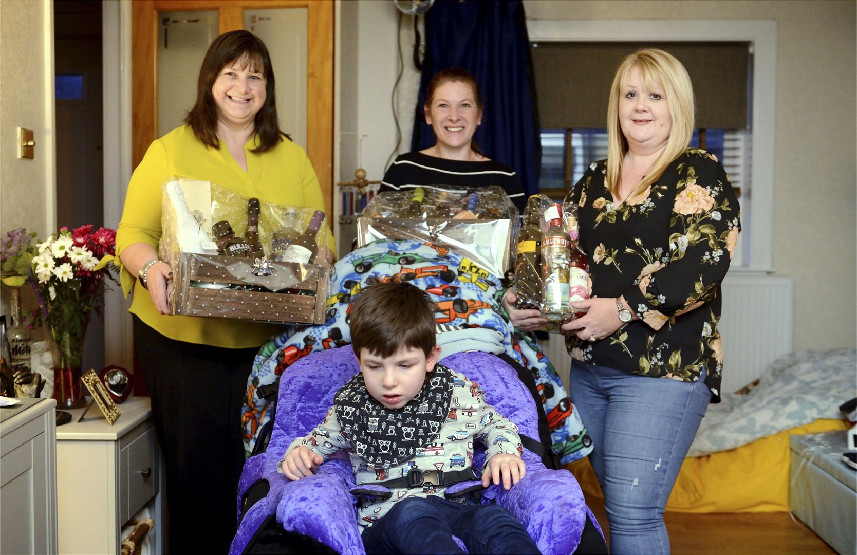 Donna Mitchell (centre) with Maureen Cooper and Paula Bremner, holding the hamper that has helped boost the fighting fund.