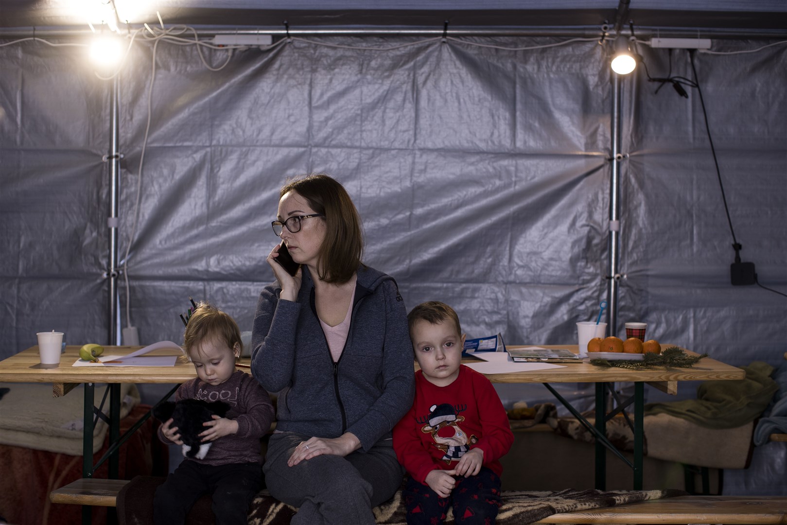 Malvina and her son Pavlo, four, and daughter Yasia, two, in the Caritas (a partner of CAFOD) tent at the Kroscienko border, Poland (Toby Madden/DEC/PA)