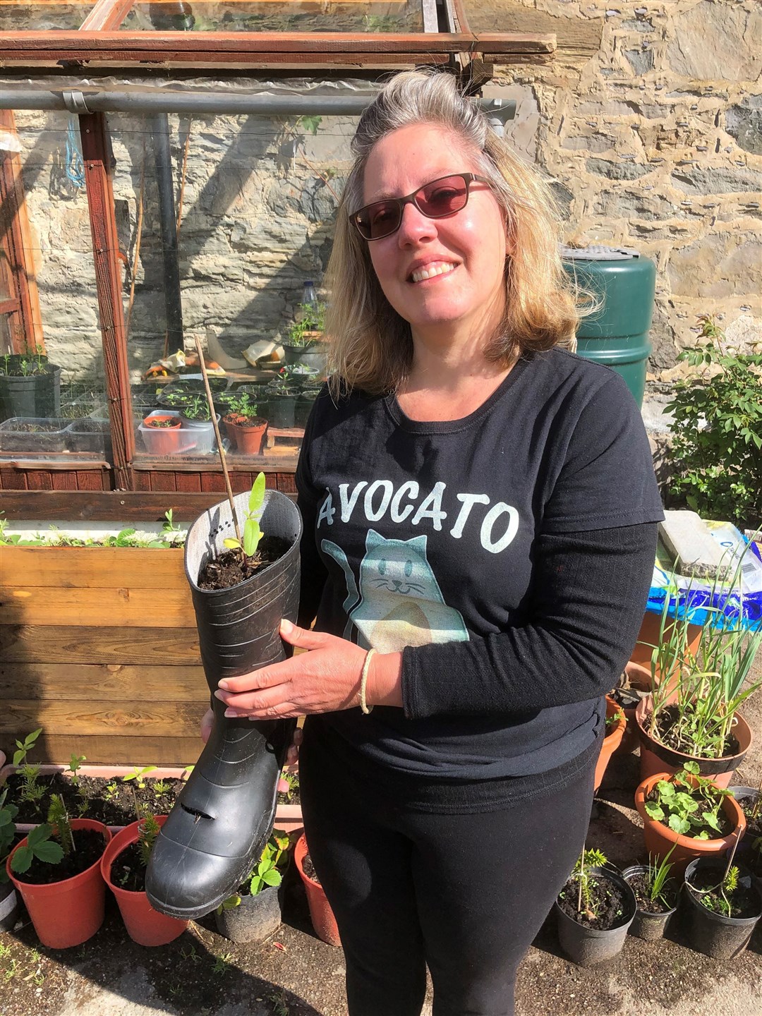 Contin resident Sherrry Morris with a seedling.