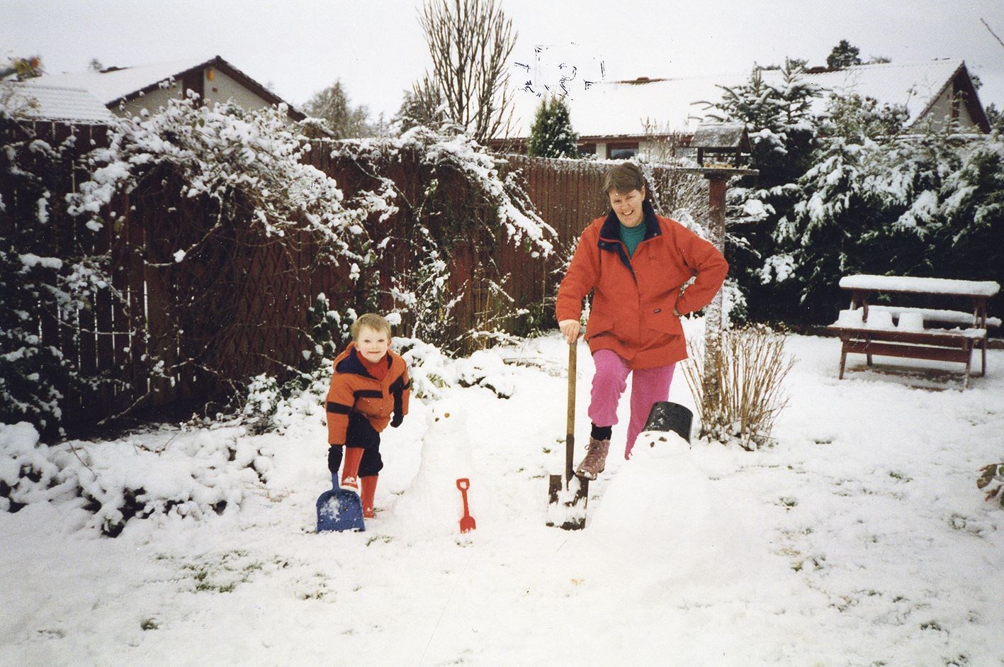Sally MacKenzie and her grandson Jack build a snowman, 1995.