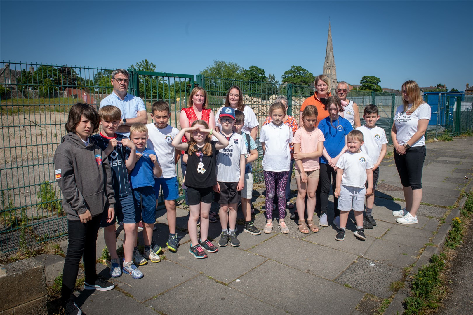 Children, parents and well-wishers adults outside the old Park Primary,, razed to the ground following a blaze in 2020. Three years on, they are accommodated at secondary school Invergordon Academy. Picture: Callum Mackay