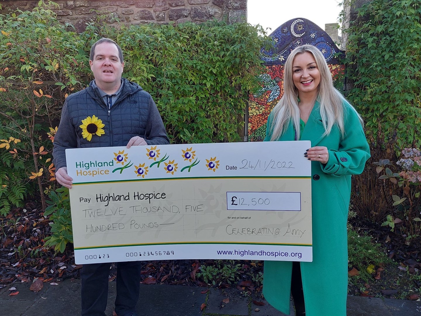 Gary Tuach hands over £12,5000 to Highland Hospice. The same sum went to Mikeysline.