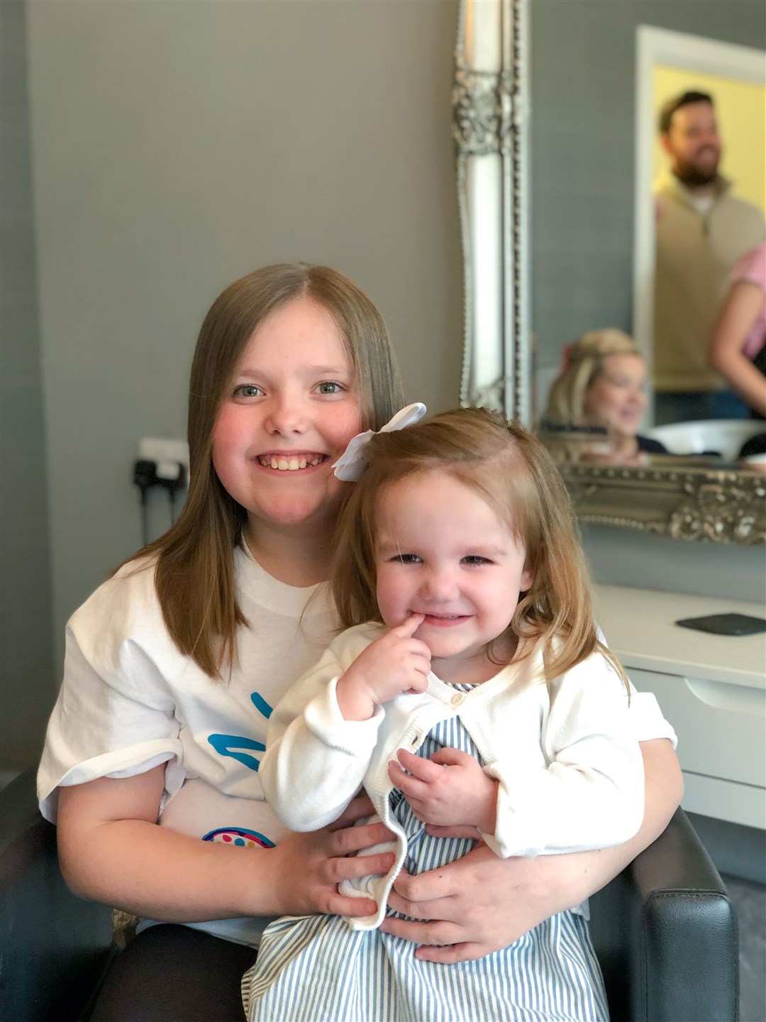 Jessica Fraser (left) was inspired by her little pal Adeline, who is two-and-a-half, to lose 10 inches of her locks to boost two charities close to her heart.