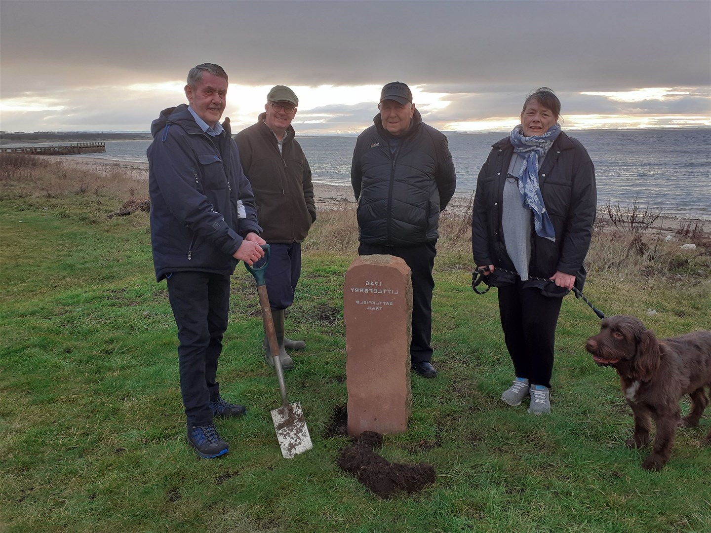 Sandy Mackay cuts the turf for the marker post at Shore Street, Golspie. In attendance are (from left) Patrick Marriott, John Melville, chairman of Golspie Heritage society, and secretary Shirley Sutherland.