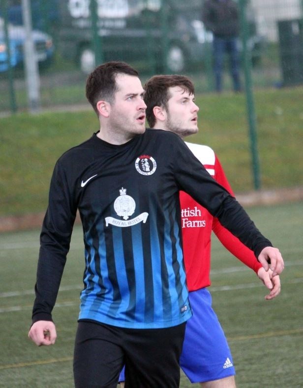 St Duthus player Liam Rostock and Orkney's Steve Hellewell. Picture: Niall Harkiss