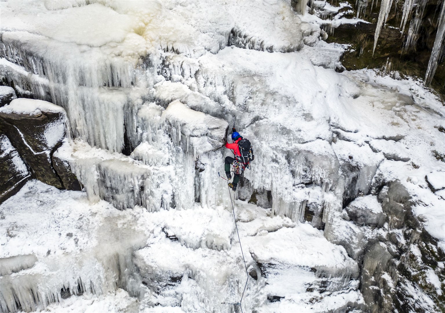 A man goes ice climbing on the frozen Kinder Downfall, High Peak in Derbyshire (Danny Lawson/PA)