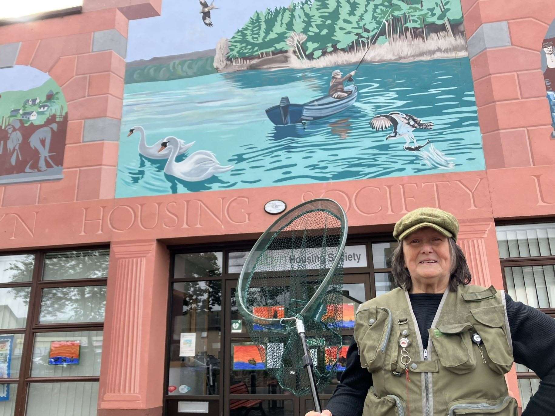 Catherine Williams, a former Kildary Angling Club member, at the Albyn Housing Society mural. Picture: Iona MacDonald.