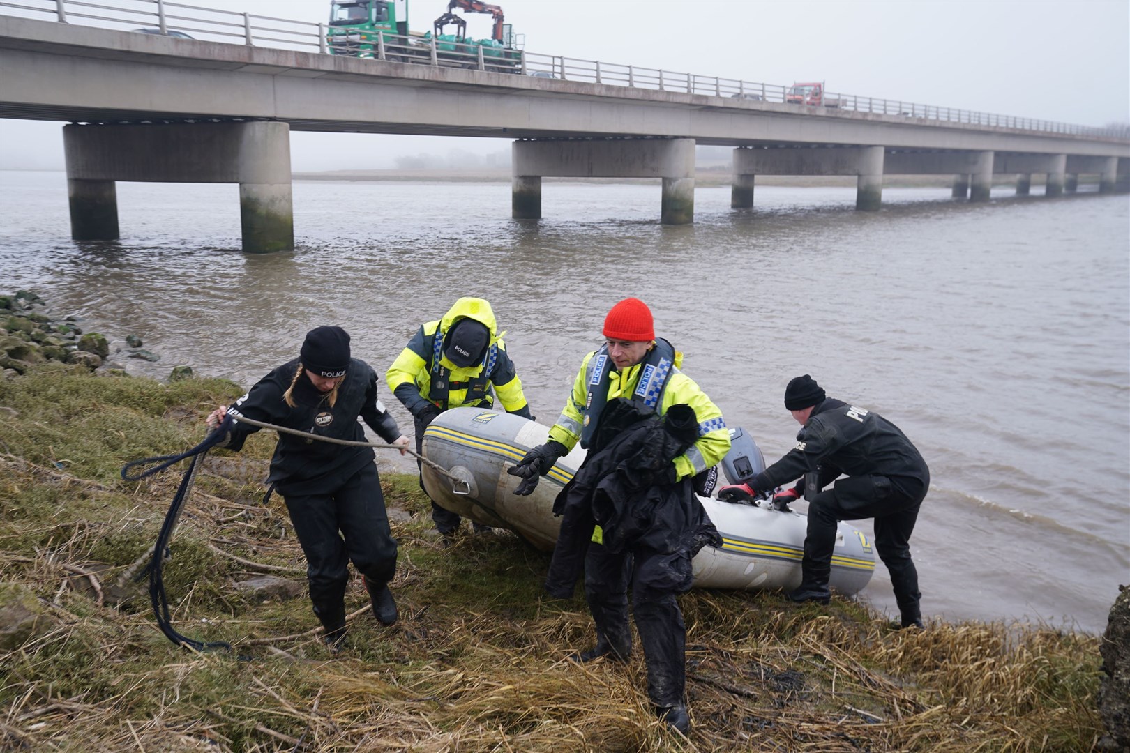 The police Search and Rescue team on the river bank near to Shard Bridge on the River Wyre (Owen Humphreys/PA)
