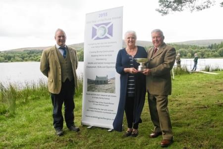 Iris MacKenzie and John Waters pictured after being presented with the inaugural Ronnie Ross conservation award by SGA chairman Alex Hogg at the Moy Game Fair.