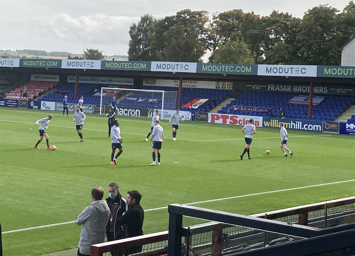 Ross County's squad warms up ahead of their Premiership match against Celtic.