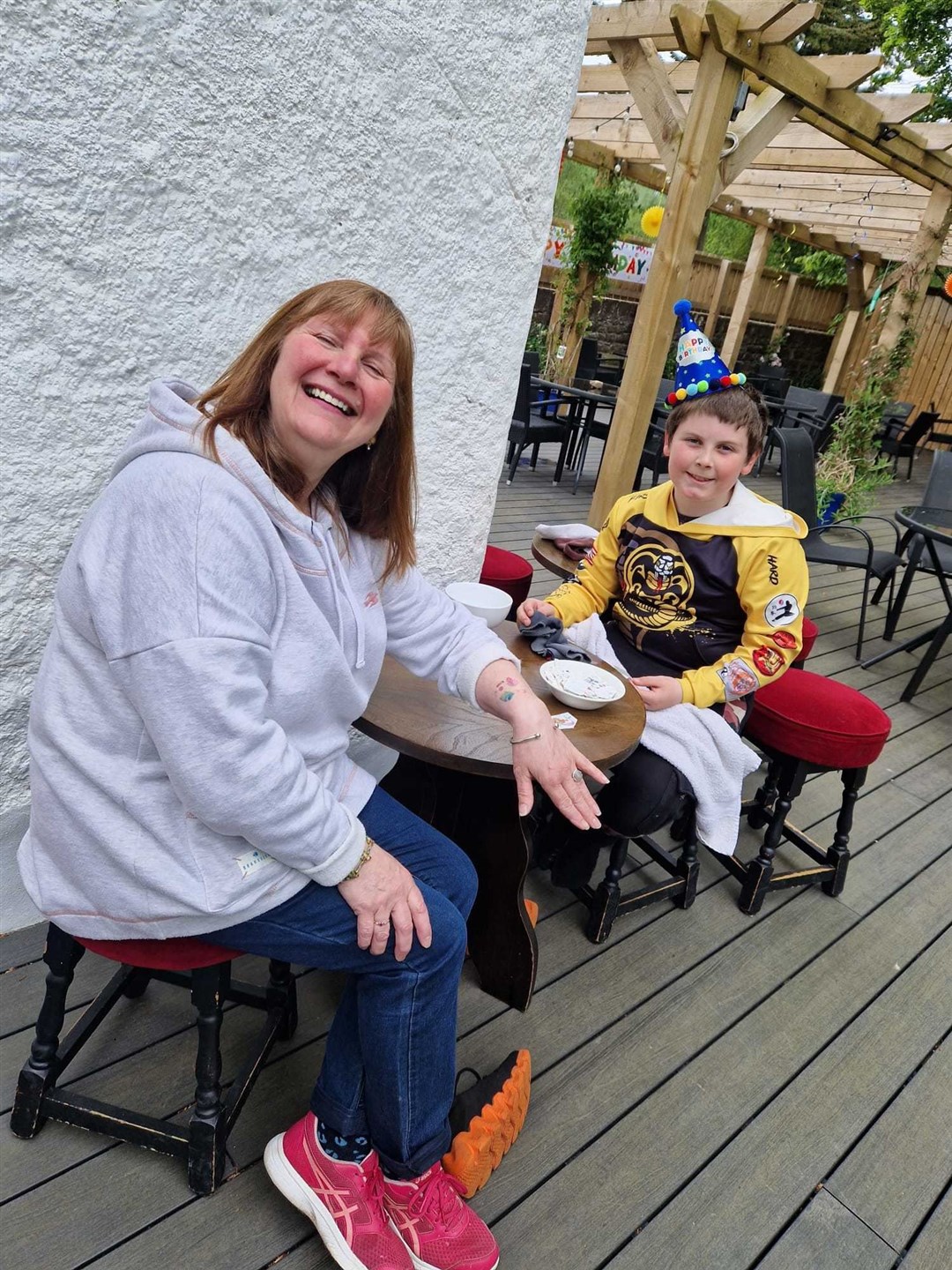 Conon Hotel first anniversary fun day: Colette Foley with Max MacPhee, getting a kids' tattoo.