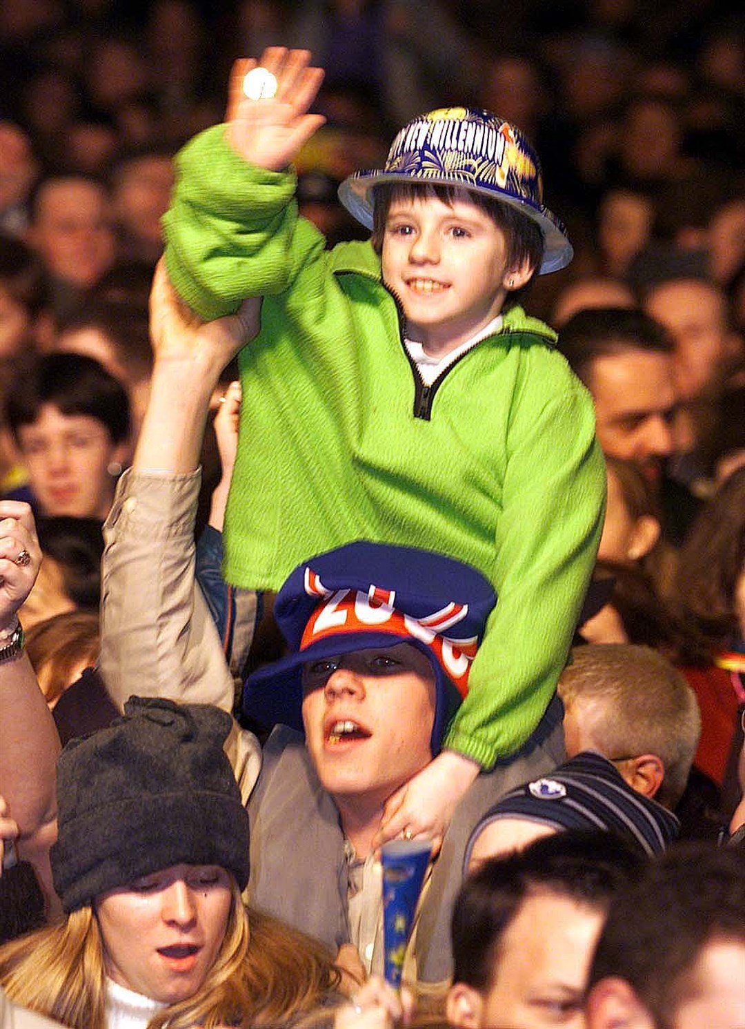 A young boy in the crowd outside Belfast City Hall amid celebrations to mark the new millennium (Paul Faith/PA)