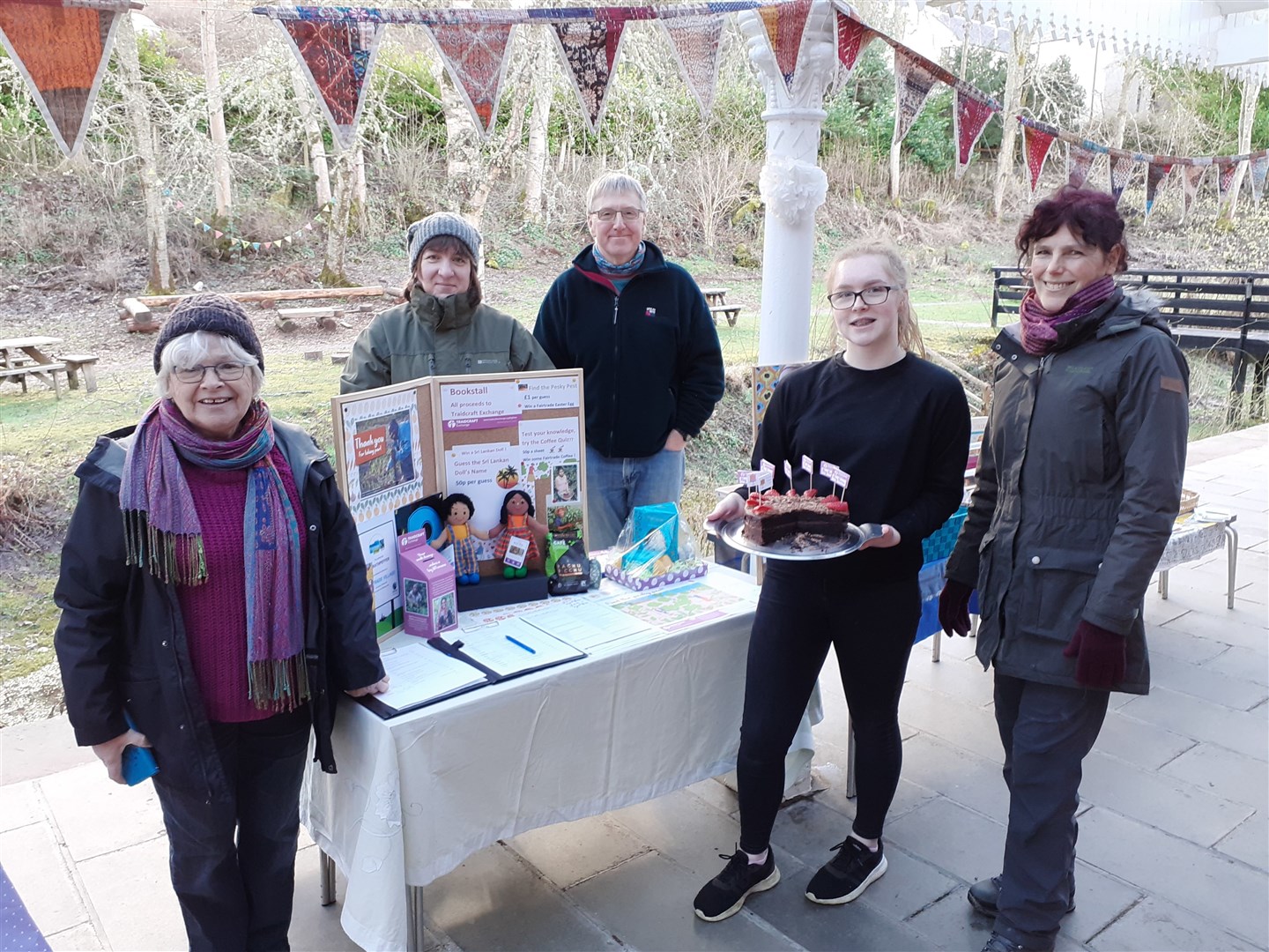 Islay Crisco from the Museum café presents their indulgent Fair Trade chocolate cake, and with heron the photo are Strathpeffer Fairtrade Group members (left to right) Pat Justad, Ann Evans, DennisOverton and Judith van Klaveren.