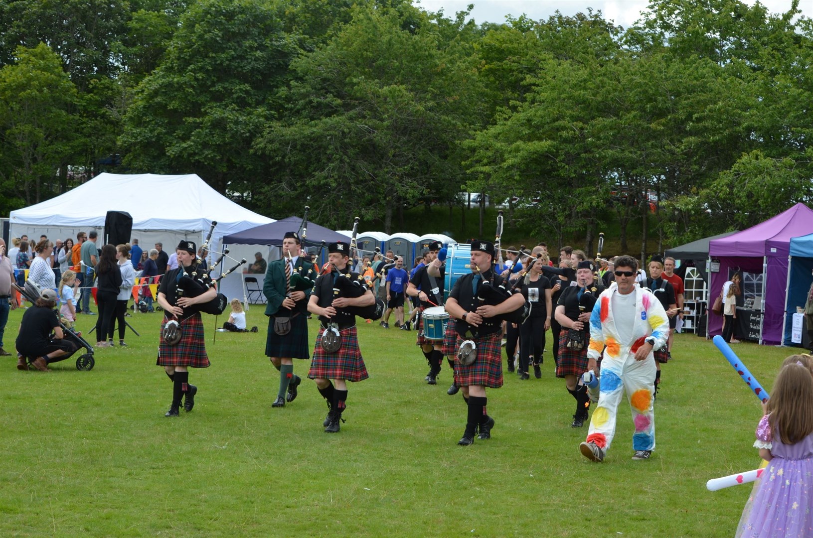 The Sutherland Caledonian Pipe Band take to the field.