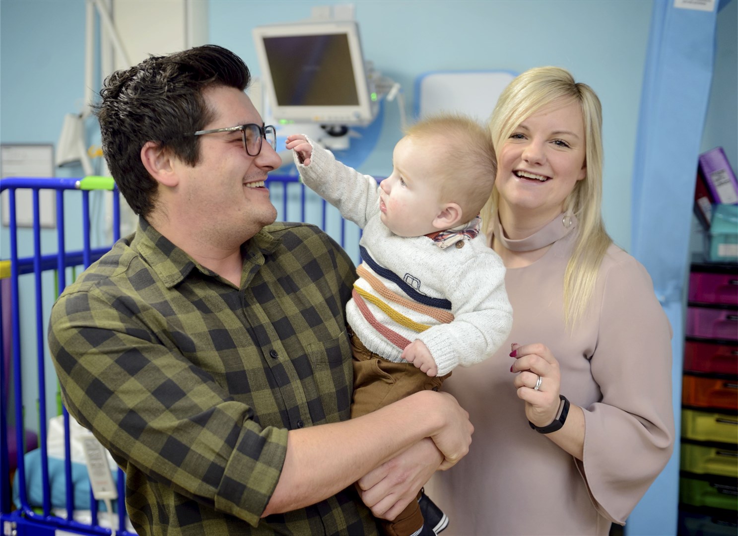 Dr Ryan Coetzee of the Raigmore Hospital children's unit was a big hit onlne after a video of him singing to one of his baby patients went viral..Dr Ryan Coetzee holding Archie McEwan standing next to Archie's mum, Michelle McEwan..Picture: James MacKenzie..