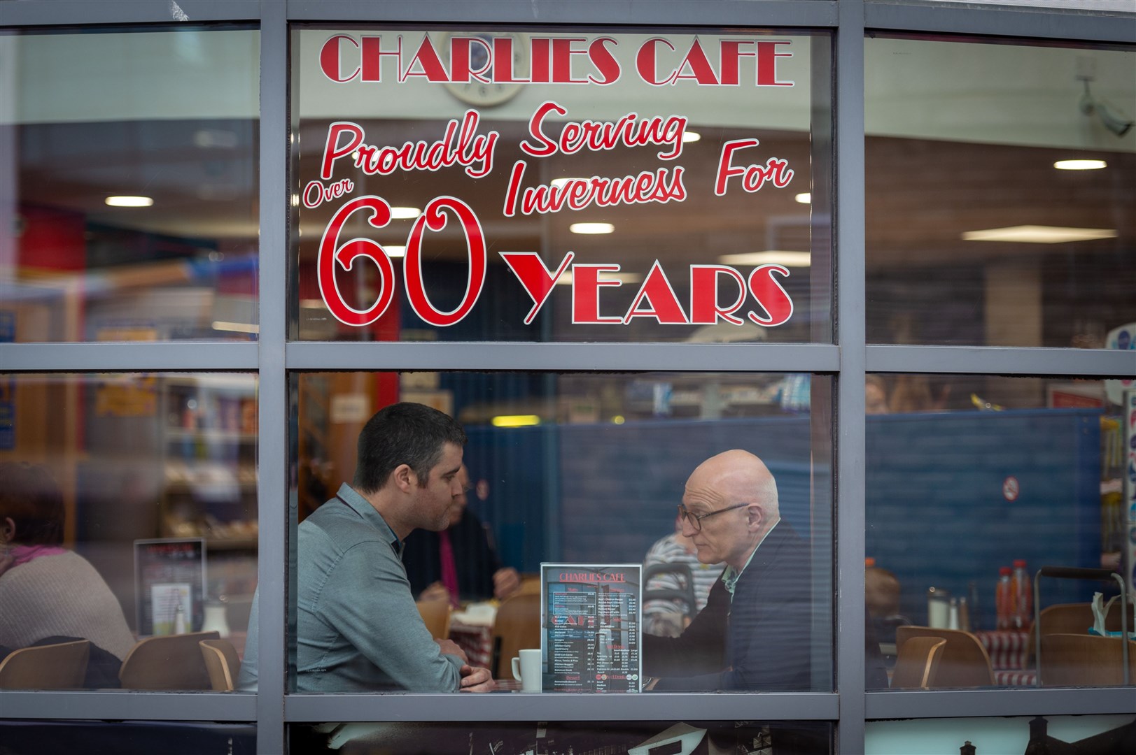 Chris Corbett, the new owner of Charlie's Cafe, chats to Martin Pieraccini whose family has owned the Inverness institution for more 70 years. Picture: Callum Mackay.