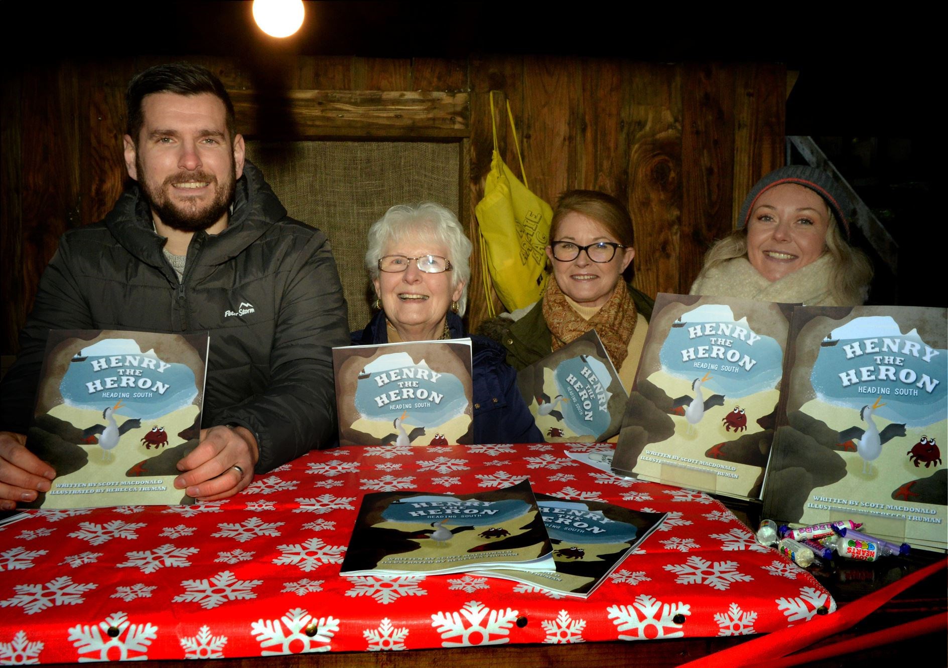 Wildwoodz Christmas Market 3 December 2021: Scott Macdonald with his new book: Henry the Heron, Nana Joanne, Rosemarie Duddy and Courtney Macdonald. Picture: James Mackenzie.