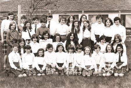 Achtercairn Junior Secondary School Gaelic Choir, now Gairloch Primary and High School, at the Wester Ross Mod in Ullapool in 1977 along with their teacher Heather Widdoes on the left in the back row.