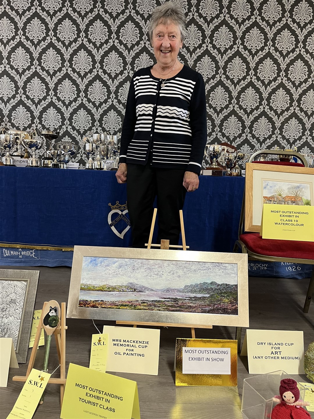 Annette Mckee with her oil painting which won most outstanding exhibit in show and cup in oil painting. Annette won five cups at the show.