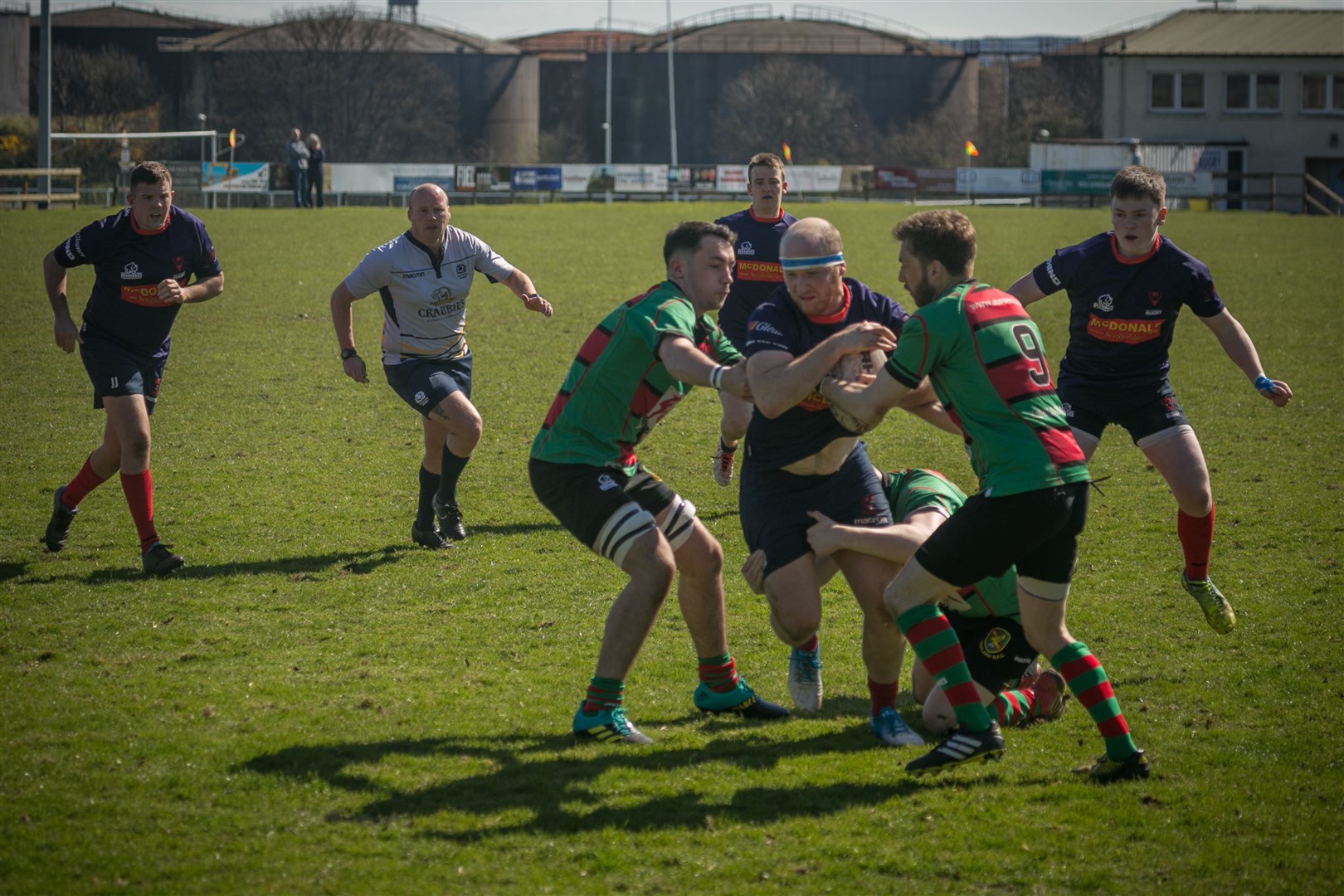 Ross Sutherland player/head coach John Mann tries to squeeze between two Highland 2nds tackles. Picture: Peter Carson