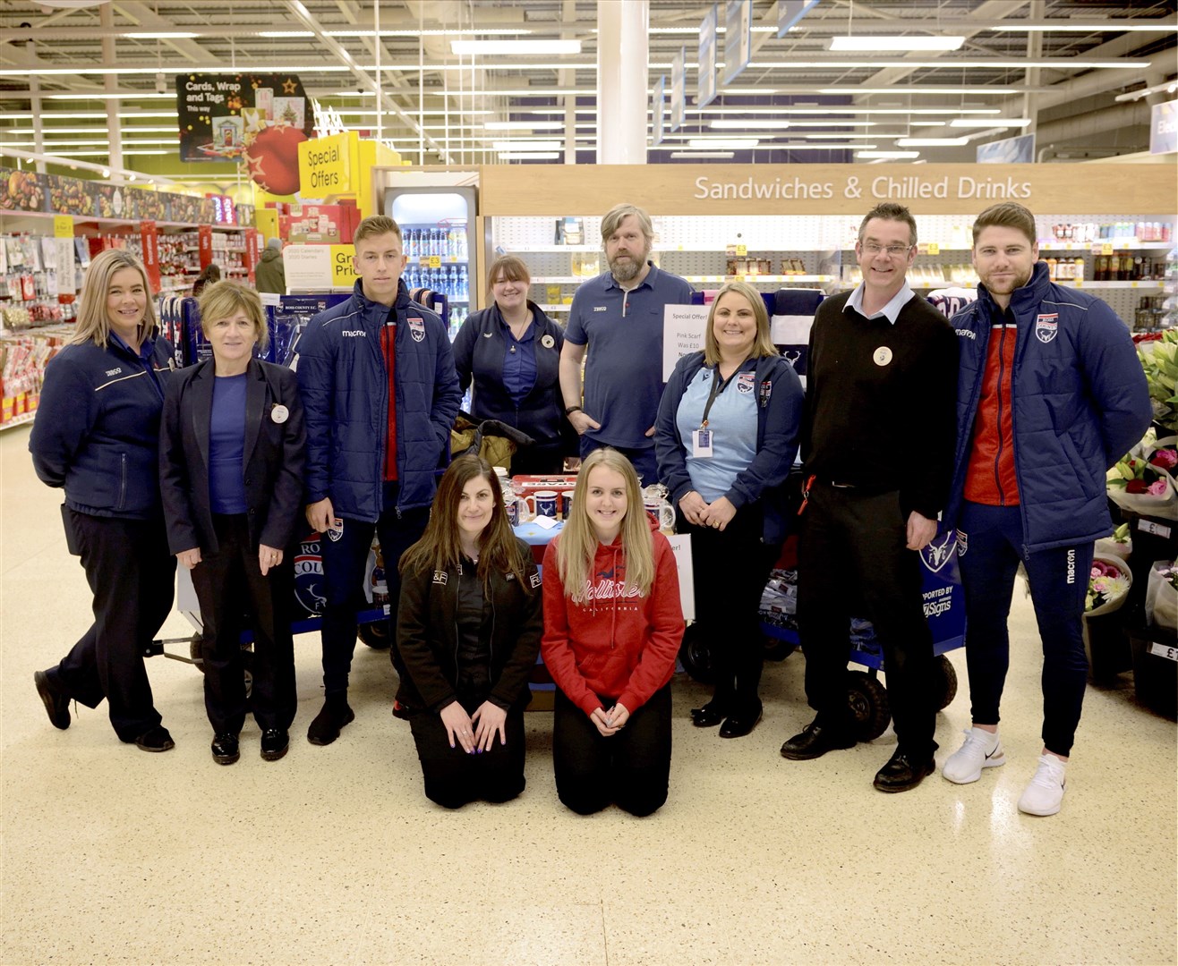 Harry Paton (3rd from left) and Iain Vigurs (far right) from Ross County with staff from Dingwall Tesco. Picture: James MacKenzie