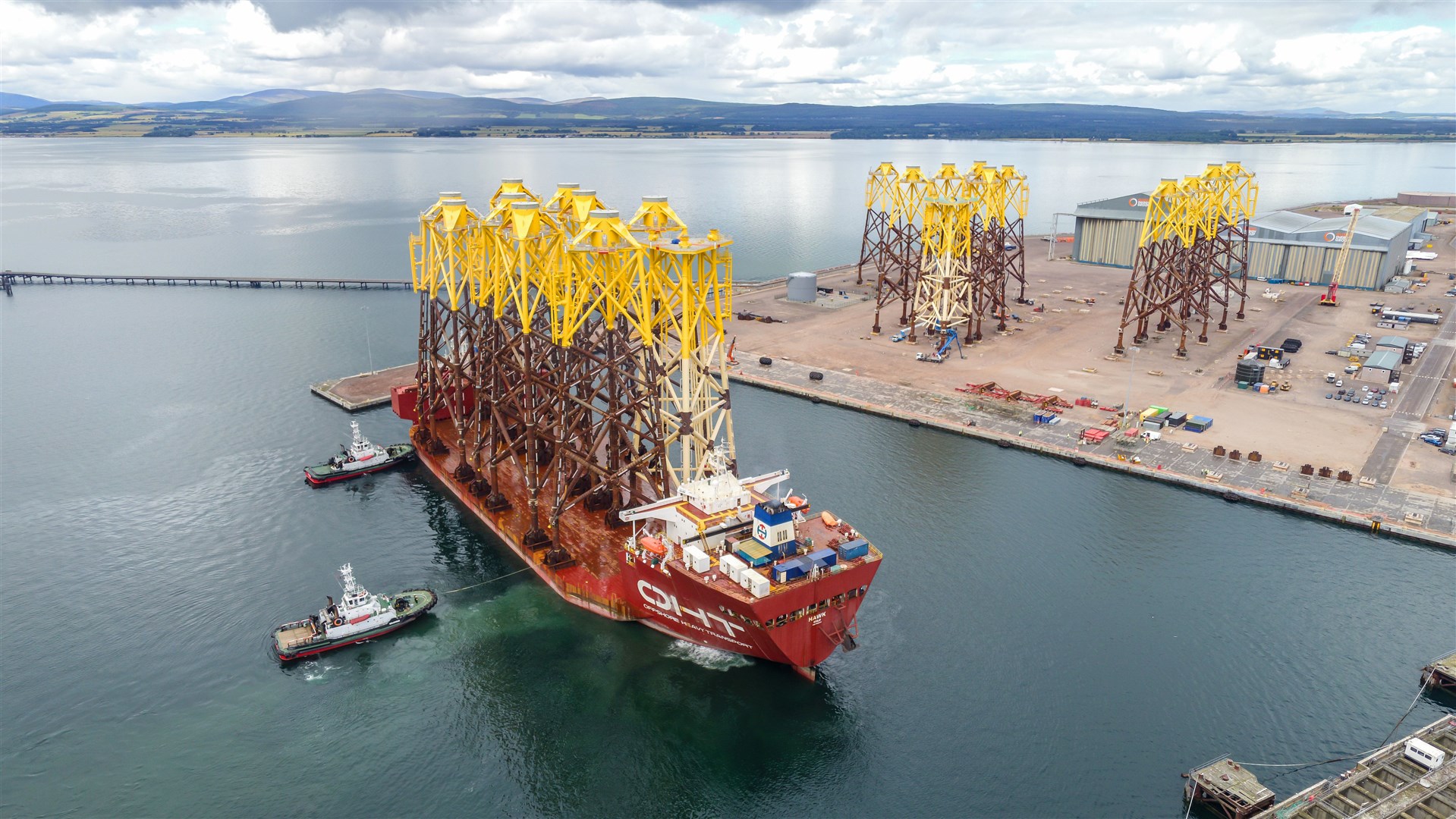 The heavy transport vessel OHT Hawk arrives on the Cromarty Firth carrying wind turbine jackets for the Moray Offshore Wind Facility to Nigg Energy Park. Image by: Malcolm McCurrach.